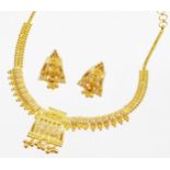 An Indian dress necklace and earring set, the necklace with central shaped panel with filigree