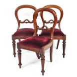 A set of three Victorian balloon back dining chairs, with mahogany backs on a curved top with