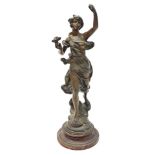 A late 19thC cast figure of a female, in dress with a flower, on a turned wooden base, 50cm high.