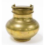 A brass storage canister, the circular fixed top with square handle, on a baluster body with a