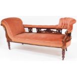 A Victorian mahogany chaise longue, with pierced back, upholstered in pink fabric, on turned legs,
