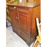 An oak finish television cabinet.