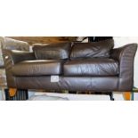 A brown leather two seater sofa.