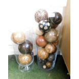 Two large glass storage vases, with collection of wooden and other decorative balls. (2)