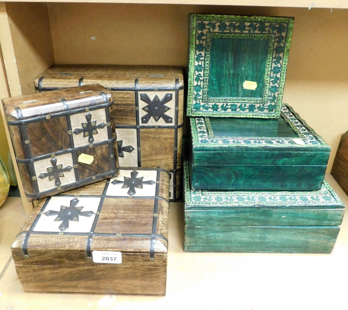 A group of storage/trinket boxes, comprising two graduated sets, one of wooden design with metal