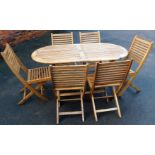 A teak garden table and chair set, the oval table with six folding chairs and an additional metal