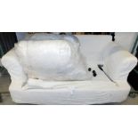 *A two seater sofa bed, with white floral cushion covers, folding out to a two person bed, 62cm