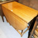 An early 20thC oak drop leaf table, on plain tapered legs, 73cm high, 89cm wide, 46cm deep when