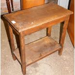 A small oak side table, with plain top and single shelf base, on column supports, 56cm high, 54cm