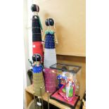 Three tall beaded figures, each with braiding and various multicoloured beading, together with a