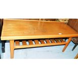 A teak coffee table, with plain top on slatted shelf base, 111cm long, 44cm deep.