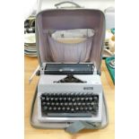 An Erika typewriter, in a grey leather case.