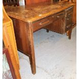 An early 20thC oak writing desk, the plain top above a long drawer with two drawer section to right,