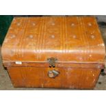 A tin trunk, with a domed top and padlock.
