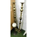Two large brass candle stands, each of bulbous and tapering form ,121cm high, together with