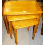 A nest of three modern light wood tables.