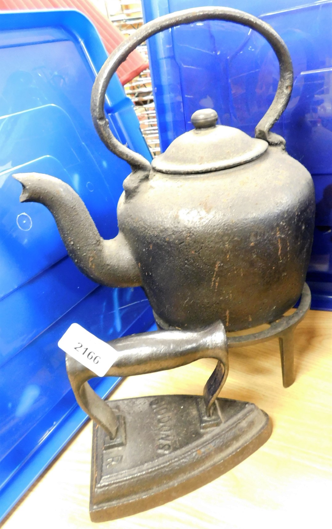 An iron kettle, stamped Didums, and a kettle on trivet. (3)