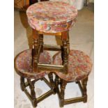 *Three framed pub stools, each with floral upholstered tops on wooden base,with brass bars, 52cm