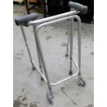 Various mobility aids, to include a zimmer frame and two walking sticks.