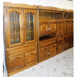 A substantial oak dining room suite, comprising display cabinet, central sideboard section and