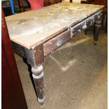 A Victorian pine kitchen table, with three drawers on tapered legs, the top with various paint