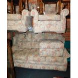 A four piece suite, upholstered in a floral fabric, comprising three seater sofa, two armchairs