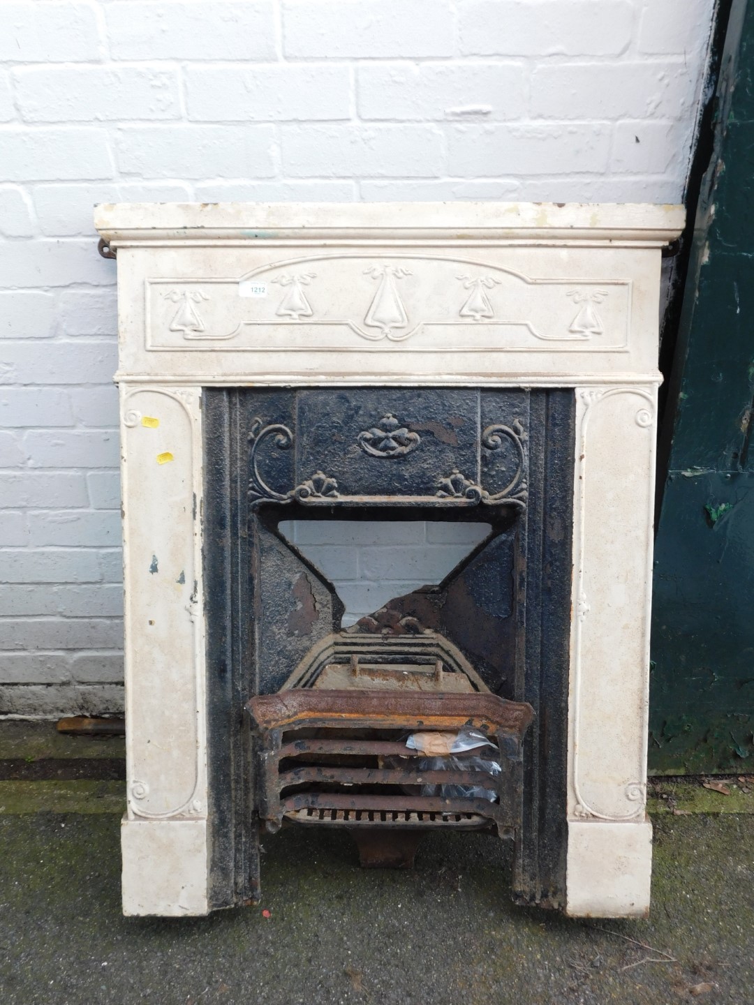 An Art Nouveau cast iron bedroom fire insert, 103cm high, 77cm wide. (AF).