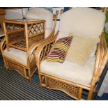 A pair of bamboo and cane conservatory armchairs, together with a matching coffee table and a