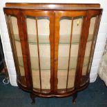 A mid 20thC walnut bow front china cabinet, enclosing two glass shelves, 114cm high, 103cm wide,