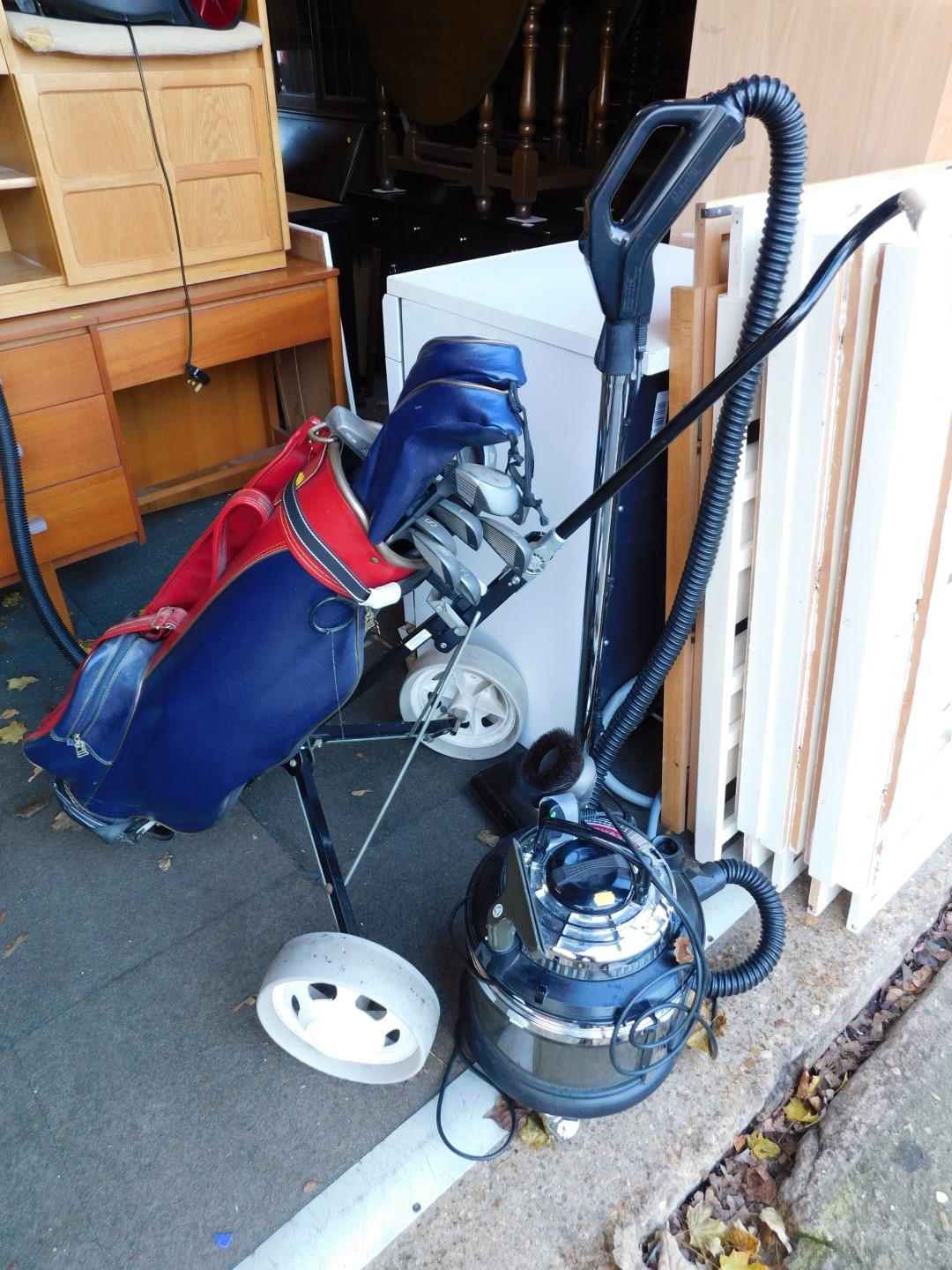 A Majestic Filter Queen vacuum cleaner, together with a golf buggy and various clubs. (2)