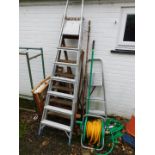 Three step ladders, various garden hand tools, director's chair, hose reel, etc. (a quantity)