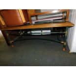 A pine and wrought iron coffee table, with glass insert, 46cm high, 128cm wide, 65cm deep.