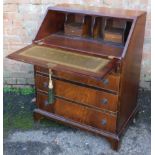 A reproduction mahogany bureau, with fitted interior, above four drawers, 96cm high, 78cm wide, 48cm