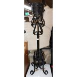 A wrought iron plant stand, with scrolled decoration, 121cm high.