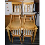 A beech table together with four beech stick back chairs, 75cm high, 114cm, wide, 72cm deep. (5)