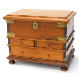 An Indian hardwood and brass chest, the top with a moulded edge enclosing a fitted interior, base
