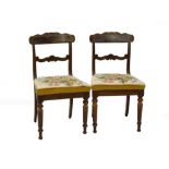 A pair of William IV mahogany side chairs, each with a carved bar back with scrolling support, a