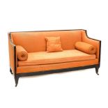 An early 19thC mahogany sofa, with a reeded show frame, upholstered in coral coloured fabric with