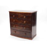 A Victorian mahogany bow fronted chest of drawers, the top with a moulded edge above two short and