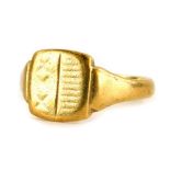 A 9ct gold signet ring, with a rectangular shield, rubbed etched decoration, stripes to one side,