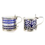 A George VI silver mustard pot, with blue glass liner, London 1921, and another with pierced