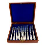 A silver plated canteen of fish knives and forks, in an associated mahogany case.