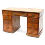 A Victorian walnut kneehole desk, the top with a moulded edge above an arrangement of nine