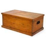 A shallow pine blanket box, with metal handles and plinth base, 33cm high, 81cm wide, 47cm deep.