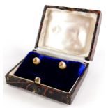 A pair of cultured pearl earrings, each with single pearl and gold six point flower end, on screw on