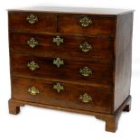 An early 19thC oak chest of drawers, the top with a moulded edge above two short and three long