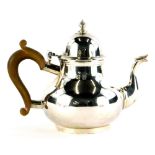 A George V silver bachelors teapot, of circular form, London 1915, stamped to the base Wilson and