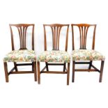 A set of three early 19thC oak dining chairs, each with a pierced vase shaped splat, a padded