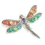 A plique-a-jour butterfly brooch, set with amethyst, rubies and marcasite, with red, yellow and