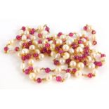 A pearl and garnet longuard necklace, with various blister and cultured pearls, with round beaded